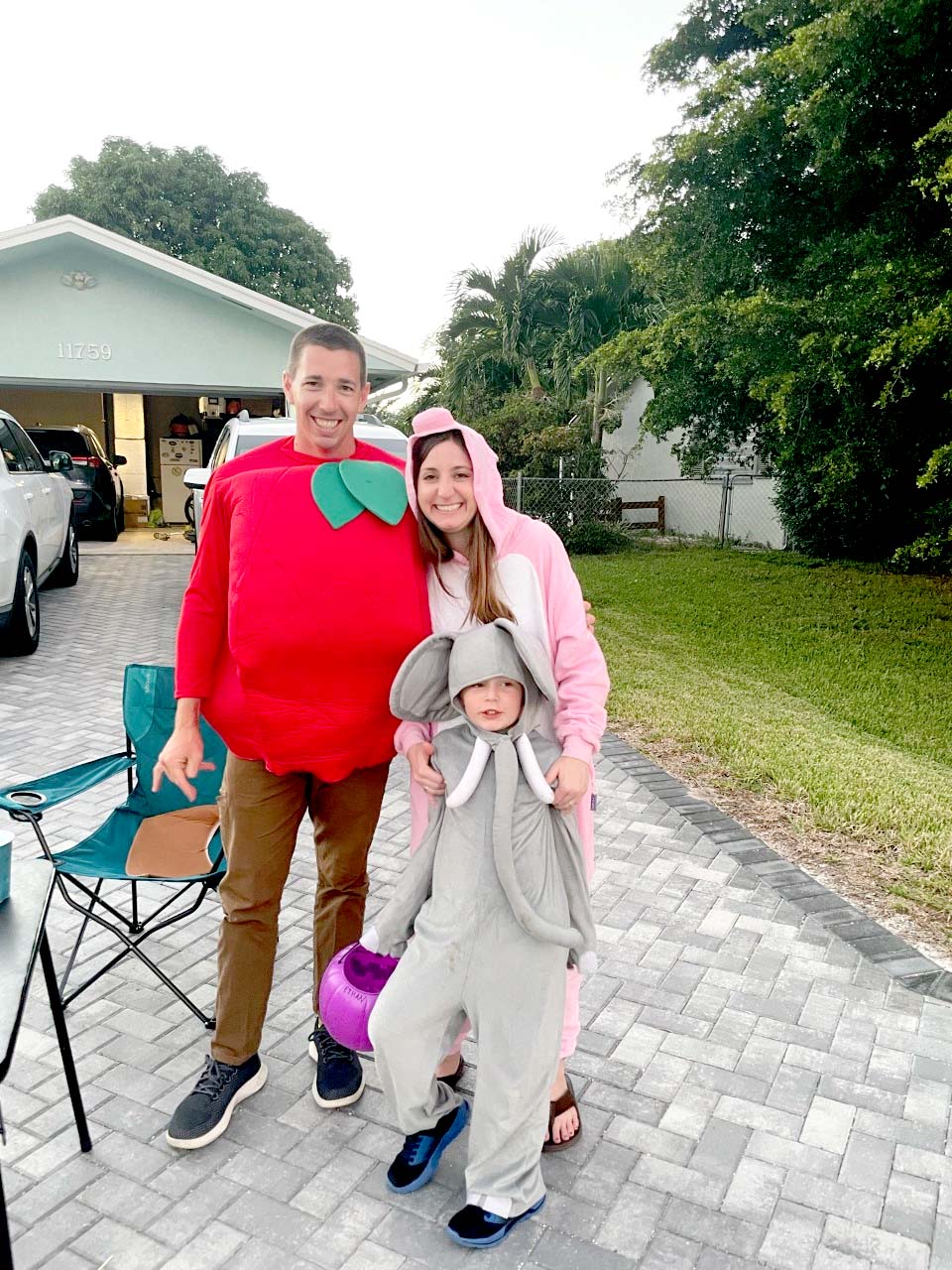 two parents and a child posing for a Halloween costume photo