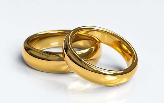 a pair of gold rings on a table